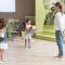full-shot-teacher-kids-playing-with-ball